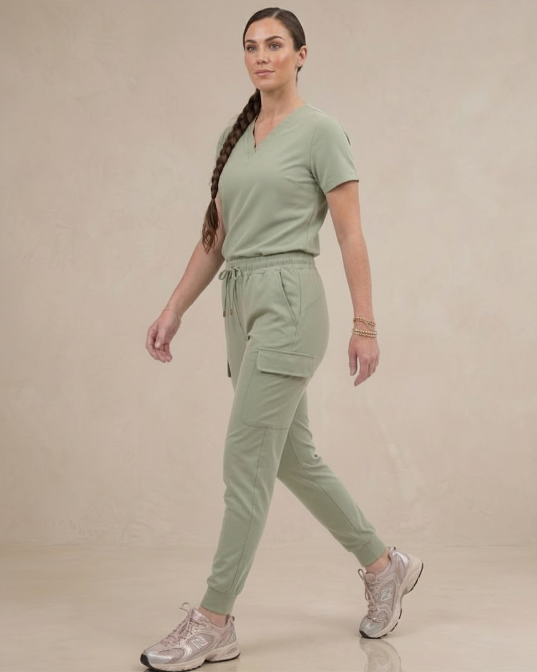 Woman wearing a green outfit with a plain background