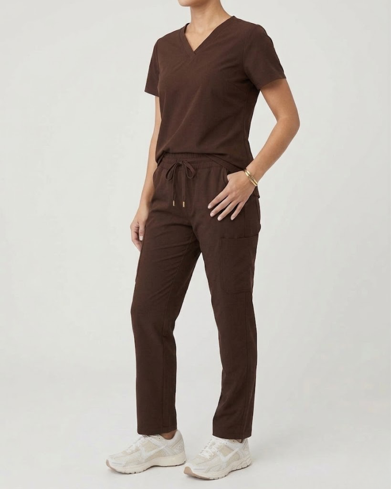 Person wearing a brown outfit with a plain background